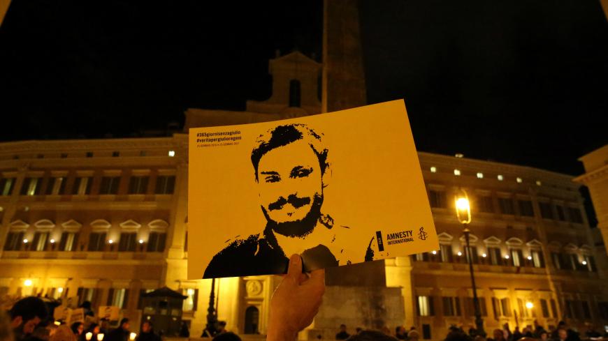 REFILE-CORRECTING BYLINE A man holds a placard during a vigil to commemorate Giulio Regeni, who was found murdered in Cairo a year ago, in downtown Rome, Italy January 25, 2017. REUTERS/Alessandro Bianchi - RC15BEE20430