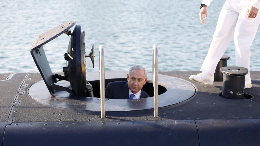 Israeli Prime Minister Benjamin Netanyahu climbs out after a visit inside the Rahav, the fifth submarine in the fleet, after it arrived in Haifa port January 12, 2016. The Dolphin-class submarines, widely believed to be capable of firing nuclear missiles, were manufactured in Germany and sold to Israel at deep discounts as part of Berlin's commitment to shoring up the security of the country set in part as a haven for Jews who survived the Holocaust.REUTERS/Baz Ratner - GF20000092315