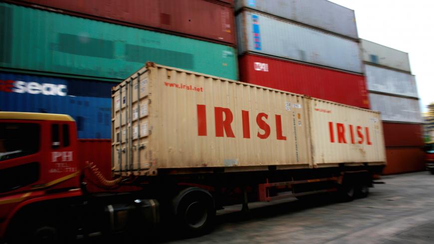 FILE PHOTO: A truck carrying Islamic Republic of Iran Shipping Lines (IRISL) containers arrives a depot in northern Singapore February 4, 2012. REUTERS/Thomas White/File Photo - S1BEUIFKRLAA