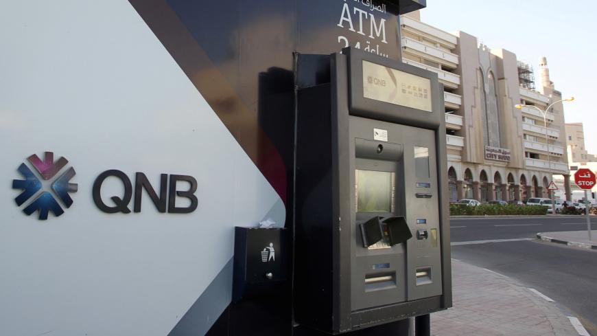 An ATM is seen outside the building of Qatar National Bank in Doha, Qatar January 16, 2018. REUTERS/Stringer - RC15CADB0E00