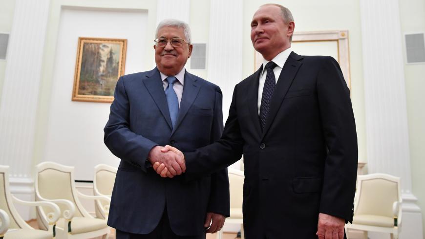 Russian President Vladimir Putin (R) shakes hands with Palestinian President Mahmoud Abbas during a meeting at the Kremlin in Moscow, Russia July 14, 2018. Pool/Yuri Kadobnov via REUTERS - RC11D68C34E0