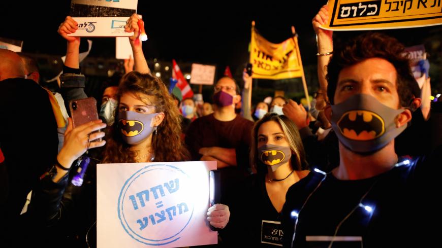 Artists protest, together with small businesses owners and other self-employed, against the government over its handing of the coronavirus disease (COVID-19) crisis and the subsequent economic fallout, at Rabin Square in Tel Aviv, Israel April 30, 2020. The placard in Hebrew reads "Actor = Profession". REUTERS/Amir Cohen - RC27FG9K27B1