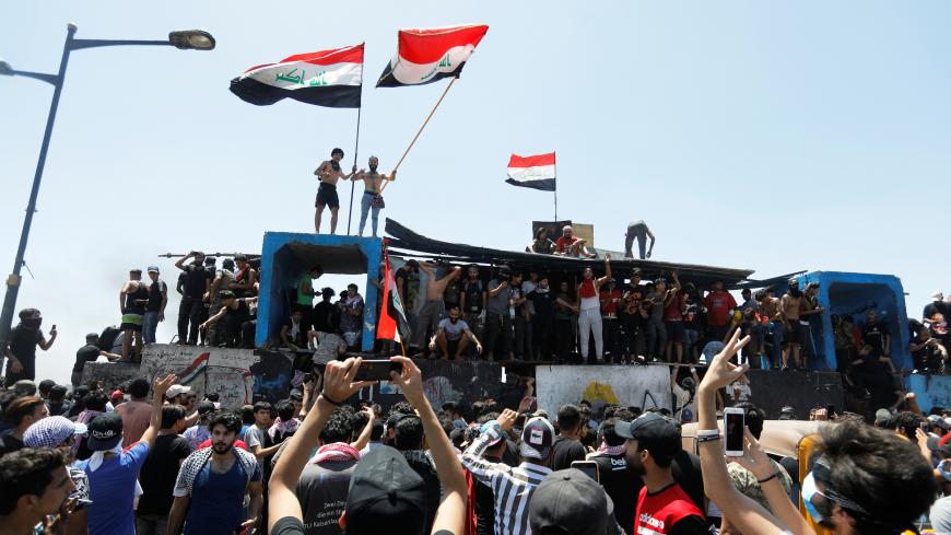 Demonstrators gesture as they take part in the ongoing anti-government protests after newly-appointed Iraqi Prime Minister Mustafa al-Kadhimi called for the release of all detained protesters, at Jumhuriya bridge in Baghdad, Iraq May 10, 2020. REUTERS/Khalid al-Mousily - RC2NLG9KIXGL