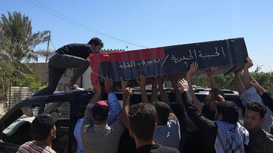 Mourners carry the coffin of an Iraqi demonstrator, who was killed during ongoing anti-government protests in Basra, Iraq May 11, 2020. REUTERS/Stringer - RC2DMG92E3JK