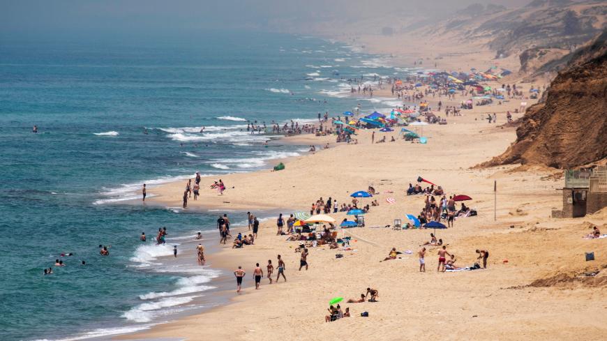 People visit a beach along the coast of the Mediterranean Sea in Ashkelon, as restrictions following the coronavirus disease (COVID-19) ease around Israel, May 16, 2020. REUTERS/Amir Cohen - RC2RPG9LGFQZ