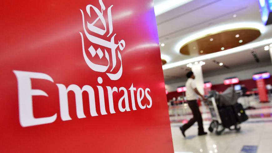 A passenger walks past an Emirates airlines logo at Dubai International Airport's  T3 in the United Arab Emirates on October 10, 2018. -  (Photo by GIUSEPPE CACACE / AFP)        (Photo credit should read GIUSEPPE CACACE/AFP via Getty Images)