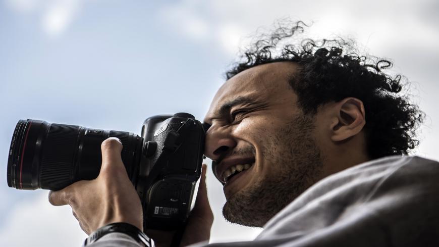 Egyptian photojournalist Mahmoud Abu Zeid, widely known as Shawkan, carries a camera at his home in the capital Cairo on March 4, 2019. - The award-winning photojournalist was released today after spending nearly six years in prison following his arrest while covering a bloody crackdown on protests, his lawyer said. Shawkan, last year received UNESCO's World Freedom Prize, dismaying the Egyptian authorities who accused him of "terrorist and criminal acts". (Photo by Khaled DESOUKI / AFP)        (Photo credi