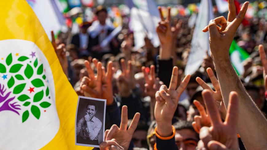 TOPSHOT - Supporters of Turkey's main pro-Kurdish People's Democratic Party (HDP) party cheer as they celebrate the Kurdish New Year during a campaign rally in Istanbul on March 24, 2019 ahead of the March 31 local elections. - Under daily attack from Turkish President and with dozens of its mayors in jail, HDP is fighting an uphill battle for this month's local elections and hopes to mobilise its supporters in the vote to capture municipal mayor posts and local councils. (Photo by Yasin AKGUL / AFP)       