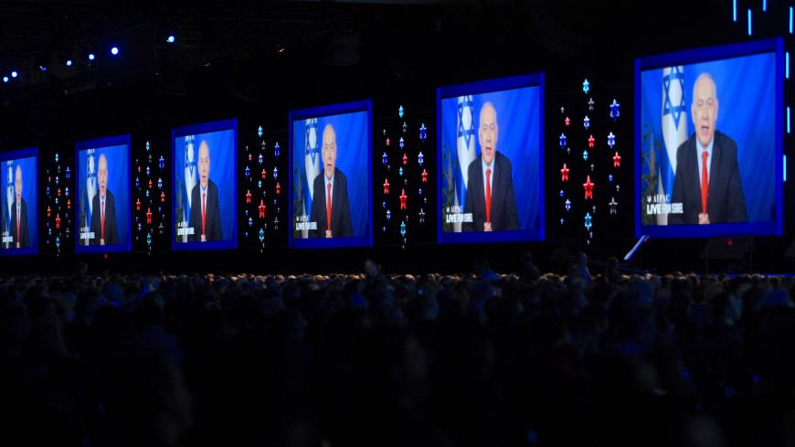 Prime Minister of Israel Benjamin Netanyahu speaks on screen from Israel, during the AIPAC annual meeting in Washington, DC, on March 26, 2019. (Photo by Jim WATSON / AFP)        (Photo credit should read JIM WATSON/AFP via Getty Images)