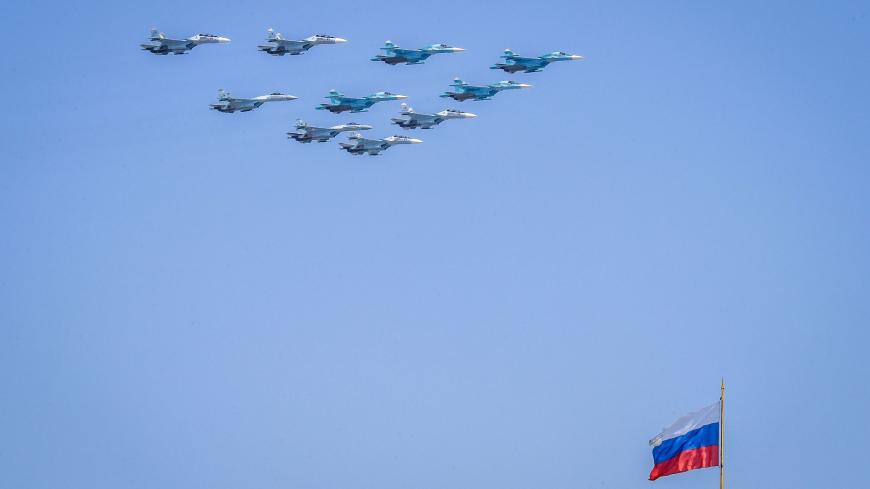 TOPSHOT - Russian Sukhoi Su-35 and Su-34 military aircrafts fly over the Russian national flag on the Kremlin palace in Moscow on May 7, 2019, during a rehearsal for the Victory Day military parade. - Russia will celebrate the 74th anniversary of the 1945 victory over Nazi Germany on May 9. (Photo by Yuri KADOBNOV / AFP)        (Photo credit should read YURI KADOBNOV/AFP via Getty Images)