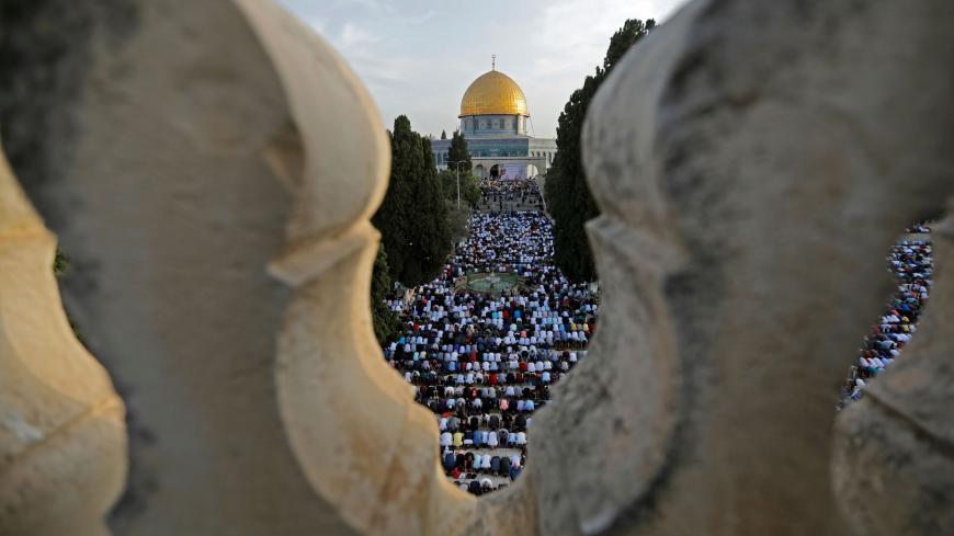 Palestinian Muslims perform the morning Eid al-Fitr prayer at the Al-Aqsa Mosque compound, Islam's third most holy site, in the Old City of Jerusalem on June 5, 2019. - Muslims worldwide celebrate Eid al-Fitr marking the end of the fasting month of Ramadan. (Photo by AHMAD GHARABLI / AFP)        (Photo credit should read AHMAD GHARABLI/AFP via Getty Images)