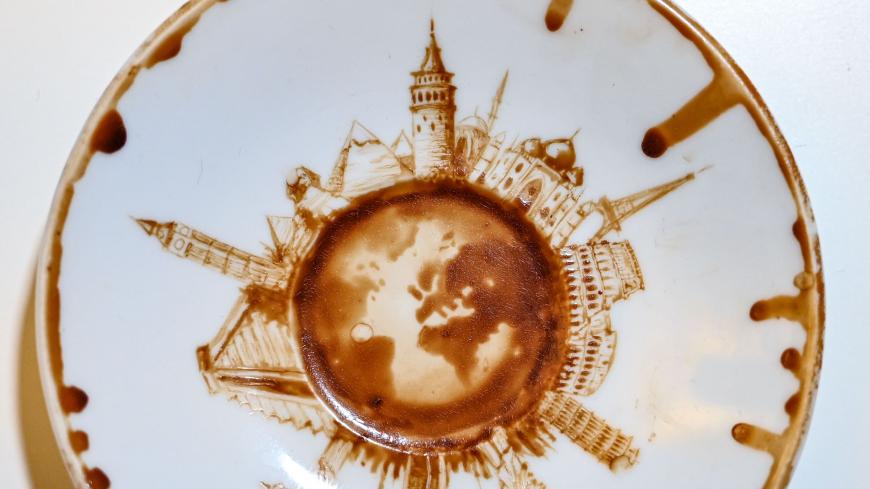 A picture taken on August 23, 2019 shows a painted Turkish coffee cup plate by Turkey's micro artist Hasan Kale in Istanbul. - His canvas could be anything from match sticks, seeds to razors and crown corks. Turkey's micro artist, also known as Turkish Microangelo in reference to Italian Renaissance sculptor and painter Michelangelo, has been hitting his brush onto tiny everyday objects for more than two decades. (Photo by Ozan KOSE / AFP) / RESTRICTED TO EDITORIAL USE - MANDATORY MENTION OF THE ARTIST UPON