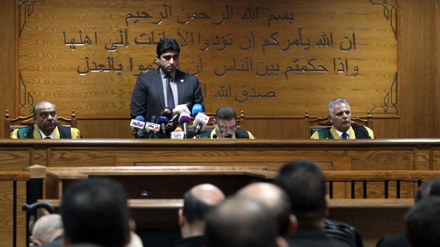 Egyptian judge Mohamed Shirin Fahmi (C) reads out a verdict and sentence as he presides over the retrial of members of the Muslim Brotherhood on charges of espionage with the Palestinian group Hamas at the Tora courthouse complex in southeastern Cairo on September 11, 2019. - An Egyptian court on September 11 sentenced senior Muslim Brotherhood figures to life, a judicial source said. The defendants included the Brotherhood leader Mohamed Badie and his deputy Khairat al-Shater who were both handed life sent