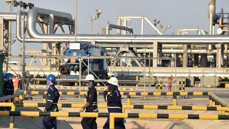 Employees of Aramco oil company work in Saudi Arabia's Abqaiq oil processing plant on September 20, 2019. - Saudi Arabia said on September 17 its oil output will return to normal by the end of September, seeking to soothe rattled energy markets after attacks on two instillations that slashed its production by half. The strikes on Abqaiq - the world's largest oil processing facility - and the Khurais oil field in eastern Saudi Arabia roiled energy markets and revived fears of a conflict in the tinderbox Gulf