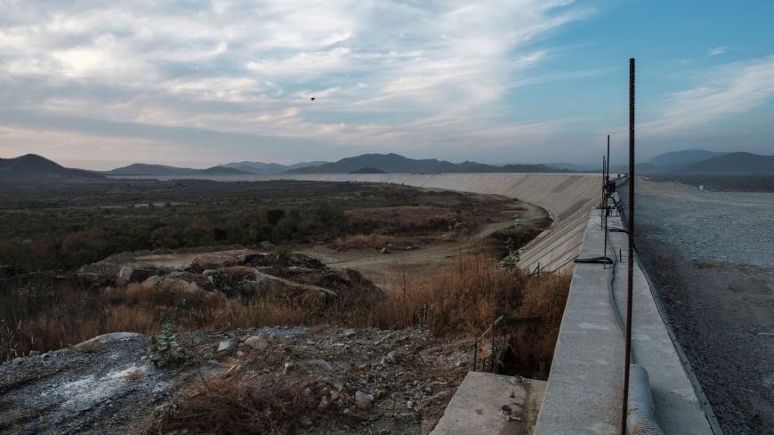 A general view of the Saddle Dam, part of the Grand Ethiopian Renaissance Dam (GERD), Ethiopia, near Guba in Ethiopia, on December 26, 2019. - The Grand Ethiopian Renaissance Dam, a 145-metre-high, 1.8-kilometre-long concrete colossus is set to become the largest hydropower plant in Africa.
Across Ethiopia, poor farmers and rich businessmen alike eagerly await the more than 6,000 megawatts of electricity officials say it will ultimately provide. 
Yet as thousands of workers toil day and night to finish the 