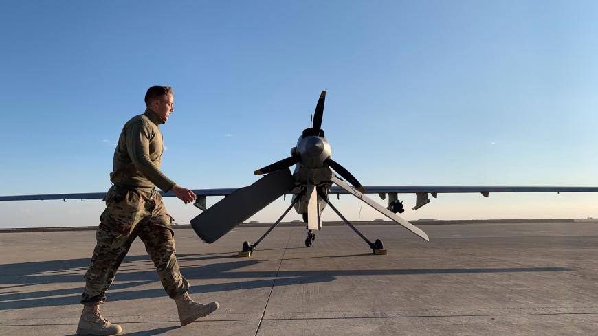 A picture taken on January 13, 2020, during a press tour organised by the US-led coalition fighting the remnants of the Islamic State group, shows a member the US forces walking past a drone in the Ain al-Asad airbase in the western Iraqi province of Anbar. - Iran last week launched a wave of missiles at the sprawling Ain al-Asad airbase in western Iraq and a base in Arbil, capital of Iraq's autonomous Kurdish region, both hosting US and other foreign troops, in an operation it dubbed a response to the kill