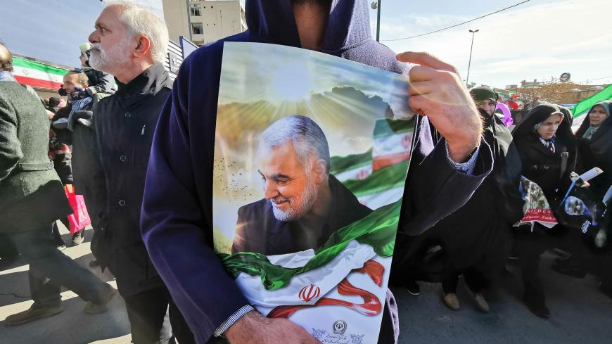 A Iranian man carries a portrait of slain Iranian General Qasem Soleimani, on the 40th day of his killing in a US drone strike, during commemorations marking 41 years since the Islamic Revolution, in the capital Tehran on February 11, 2020. - Thousands of Iranians massed for commemorations marking 41 years since the Islamic Revolution, in a show of unity at a time of heightened tensions with the United States. The celebrations mark the day that Shiite cleric Khomeini returned from exile and ousted the shah'
