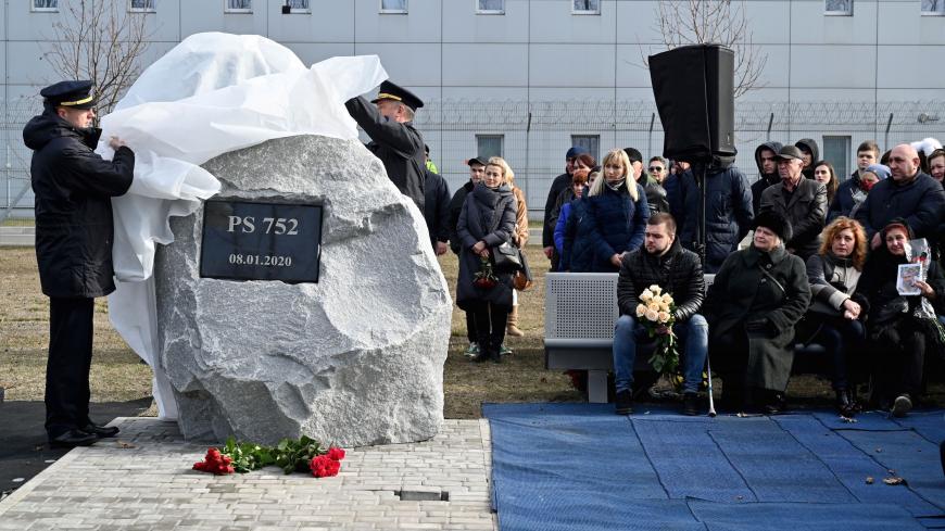 Relatives and colleagues of the 11 Ukrainians who died in a plane mistakenly shot down by Iran in January, attend a ceremony unveiling a memorial stone at the site of the future monument at the Boryspil International airport outside Kiev on February 17, 2020. (Photo by Sergei SUPINSKY / AFP) (Photo by SERGEI SUPINSKY/AFP via Getty Images)