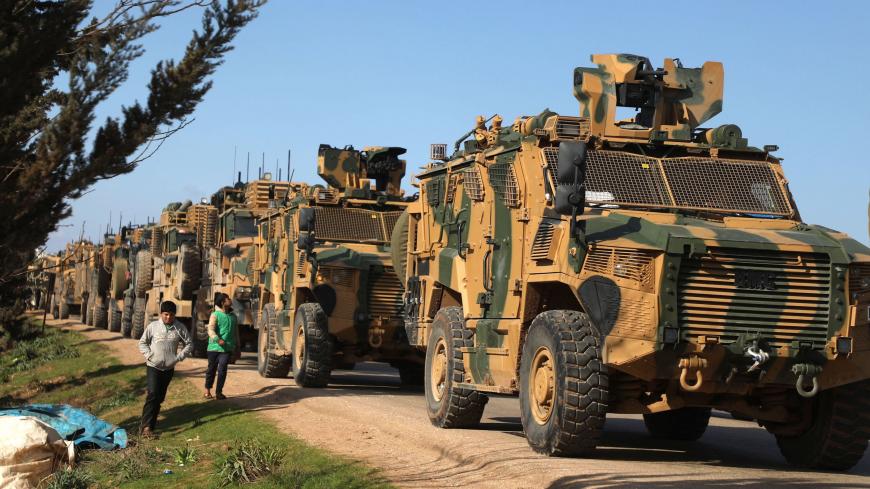 A Turkish military convoy is seen parked near the town of Batabu on the highway linking Idlib to the Syrian Bab al-Hawa border crossing with Turkey, on March 2, 2020. - The Syrian government pledged to repel Turkish forces attacking its Russia-backed troops in northwestern Syria as tensions spike between Damascus and Ankara. Since December, Syrian regime forces have led a deadly military offensive against the last major opposition stronghold of Idlib, where Turkey supports some rebel groups. Damascus said i