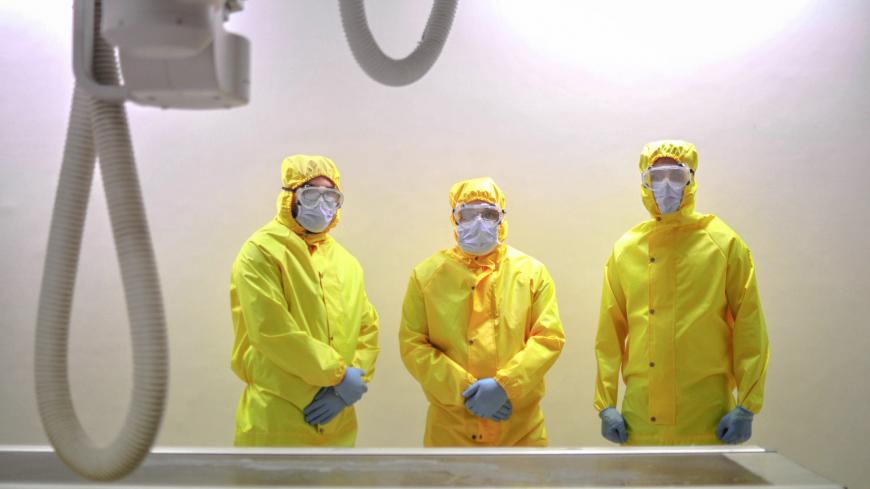 TOPSHOT - A picture taken by a doctor at the Sheikh Zayed hospital in the Egyptian capital Cairo on April 25, 2020, shows radiology technicians, wearing protective gear, posing for a picture in a lab in the isolated ward for the coronavirus (COVID-19) patients. - The virus has so far infected over 8,000 people and claimed 514 lives in Egypt, according to official figures. (Photo by Yahya DIWER / AFP) (Photo by YAHYA DIWER/AFP via Getty Images)