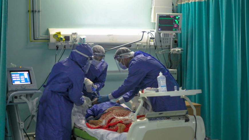 A picture taken by a doctor at the Sheikh Zayed hospital in the Egyptian capital Cairo on April 29, 2020, shows members of a medical staff, wearing protective gear, intubating a patient in the isolated ward for the coronavirus (COVID-19) patients. - The virus has so far infected over 8,000 people and claimed 514 lives in Egypt, according to official figures. (Photo by YAHYA DIWER / AFP) (Photo by YAHYA DIWER/AFP via Getty Images)