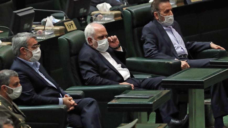 Iranian Foreign Minister Mohmmad Javad Zarif (C) attends during the inaugural session of the new parliament in Tehran on May 27, 2020, following February elections. - The 11th legislature since the Islamic revolution of 1979 opened as the country's economy, which has been hard hit by the novel coronavirus, gradually returns to normal. Rouhani, who is in the final year of his second and final term, called on MPs, collectively and individually, to place the "national interest above special interests", "party 