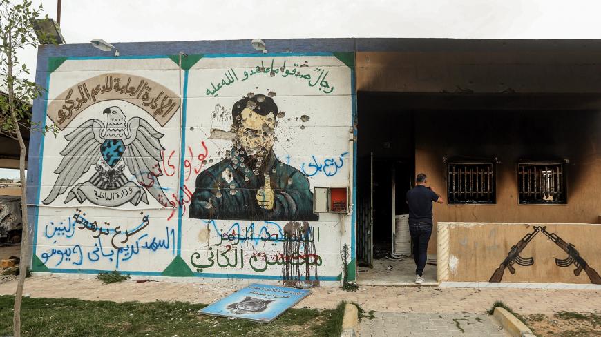 This picture taken on June 11, 2020 shows a view of a mural depicting Mohsen al-Kania a commander of forces loyal Libya's eastern strongman Khalifa Haftar drawn on the wall of a detention facility formerly controlled by them, which fell into the control of security forces affiliated with the Libyan Government of National Accord (GNA)'s Interior Ministry in the town of Tarhuna, about 65 kilometres southeast of the capital Tripoli. (Photo by Mahmud TURKIA / AFP) (Photo by MAHMUD TURKIA/AFP via Getty Images)