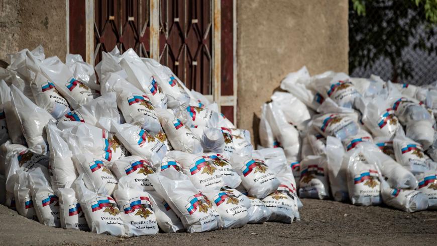 TOPSHOT - Bags of Russian humanitarian aid are seen laying on the ground, after residents refused to accept them, in the town of Derouna Arha near the Syrian border with Turkey on June 16, 2020. (Photo by Delil SOULEIMAN / AFP) (Photo by DELIL SOULEIMAN/AFP via Getty Images)