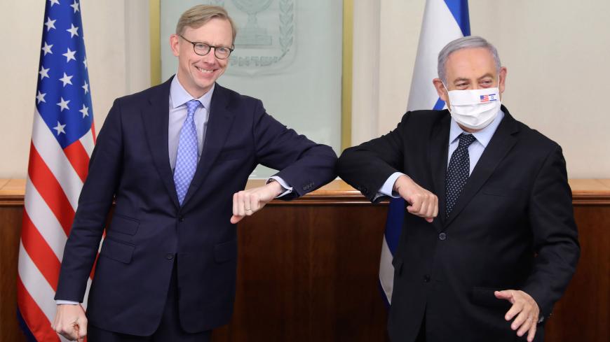 US special representative for Iran Brian Hook (L) performs an elbow shake with Israeli Prime Minister Benjamin Netanyahu (R), clad in face mask bearing the US and Israeli flags, at the Prime Minister's Office in Jerusalem on June 30, 2020. (Photo by ABIR SULTAN / POOL / AFP) (Photo by ABIR SULTAN/POOL/AFP via Getty Images)