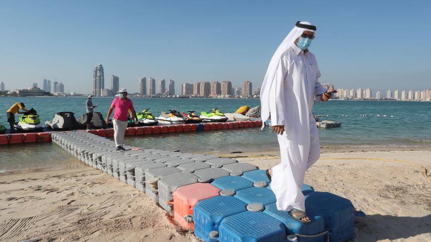 Men, wearing protective masks, walk on a plastic pier at Katara beach in the Qatari capital Doha on July 1, 2020 as the country moves into the second phase of its four-step plan to lift COVID-19 lockdown. - People in Qatar cautiously returned to beaches as the Gulf nation, which has one of the world's highest total per capita coronavirus infection rates, continued to reopen society.
Sun-lovers and jetski enthusiasts braved temperatures of 39 degrees celsius (102 Fahrenheit) at Doha's Katara Cultural Village
