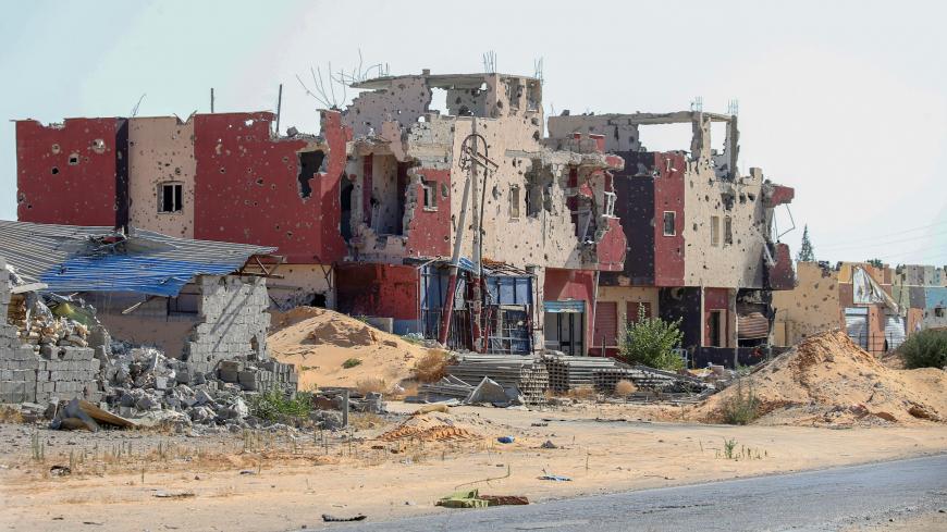 A picture shows a residential building, damaged during the 14 months of fighting between the UN recognized Government of National Union (GNA) and Marshal Khalifa Haftar, in a southern neighbourhood in the capital Tripoli on July 9, 2020. - The battle for Tripoli has created devastation in the industrial zones and suburbs around the capital, where small and medium entreprises have been badly damaged. In post-Kadhafi Libya, young and vibrant entrepreneurs are trying to make a difference despite the mammoth ch