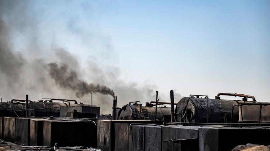 This picture taken on July 19, 2020 shows a general view of a makeshift refinery using burners to distill crude oil in the village of Bishiriya in the countryside near the town of Qahtaniya west of Rumaylan (Rmeilan) in Syria's Kurdish-controlled northeastern Hasakeh province. - Oil pollution in Syria has become a growing concern since the 2011 onset of a civil war that has taken a toll on oil infrastructure and seen rival powers compete over control of key hydrocarbon fields. In the Kurdish-held northeast,