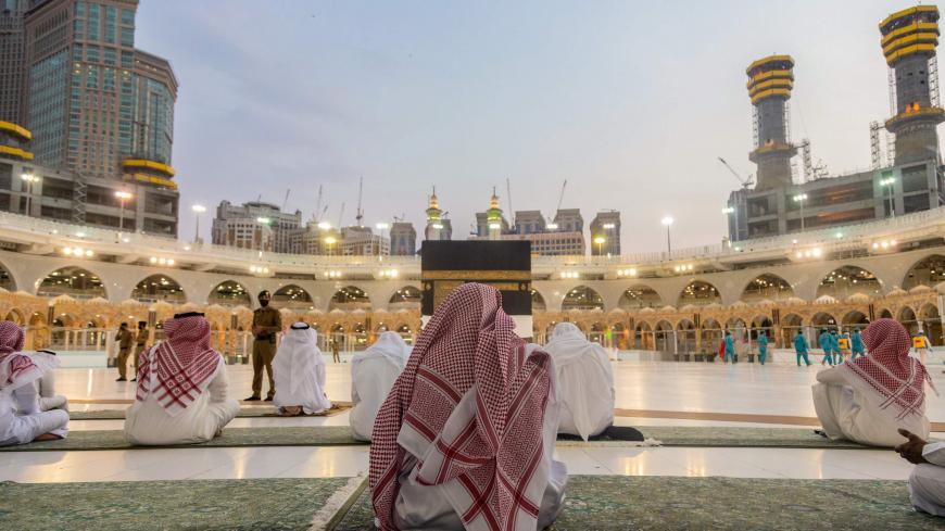A handout picture provided by the Saudi Ministry of Media shows members of the hajj staff gathering around the Kaaba, Islam's holiest shrine, at the Grand Mosque in the holy city of Mecca, on July 26, 2020, amid preparations for the Hajj pilgrimage season. (Photo by - / Saudi Ministry of Media / AFP) (Photo by -/Saudi Ministry of Media/AFP via Getty Images)