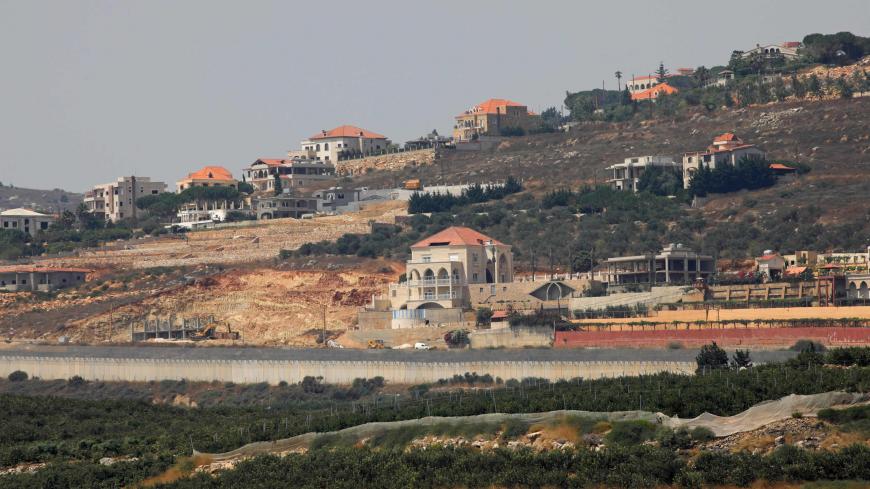 A picture taken from the northern Israeli town of Metula shows the southern Lebanese village of Kfar Kila behind the concrete barrier wall along the border between the two countries, on July 28, 2020. - Israel said it had repelled an attempt by Hezbollah fighters to penetrate its northern border on July 27, but the Lebanese group denied any involvement in the incident.  
The border clash, which Israel said included an exchange of fire between its troops and gunmen, followed days of reported heightened tensi