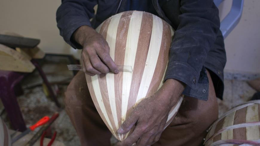 Hammad Atwa, a Palestinian man who makes lutes, known in Arabic as an "Oud", works on a musical instrument at the Khan Younis refugee camp in the southern Gaza Strip on February 19, 2014. Hammad sells his handmade lutes for 300 American dollars a piece. AFP PHOTO / SAID KHATIB        (Photo credit should read SAID KHATIB/AFP via Getty Images)