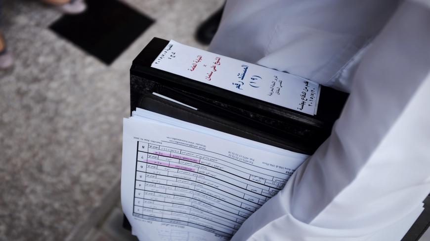 A Bahraini lawyer, S Mohsin Al-Alawi (R) holds the defence case file for Sheikh Ali Salman, head of the Shiite opposition movement Al-Wefaq, as he leaves the court after the sentence hearing on June 16, 2015, in Manama. A Bahrain court jailed Shiite opposition leader Salman for four years after convicting him of inciting disobedience and hatred in the Sunni-ruled kingdom, a judicial source said. AFP PHOTO / MOHAMMED AL-SHAIKH        (Photo credit should read MOHAMMED AL-SHAIKH/AFP via Getty Images)