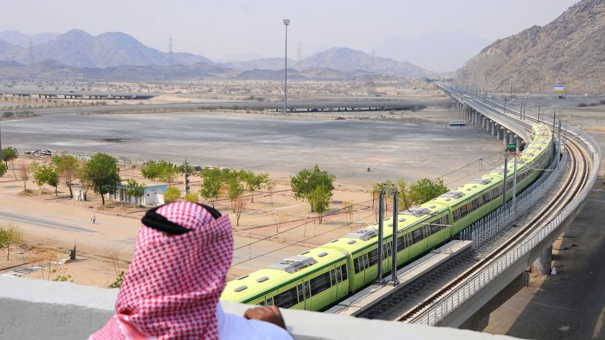 A man stands watching the newly-opened Holy Sites metro light rail in the western Saudi city of Mecca on November 2, 2010. - The Chinese-built monorail project, will link Mecca with the holy sites of Mina, Arafat and Muzdalifah, and will operate for the first time during the Hajj this month at 35 percent capacity to ferry Saudi nationals who will take part in the upcoming annual Muslim pilgrimage. (Photo by AMER HILABI / AFP)        (Photo credit should read AMER HILABI/AFP via Getty Images)