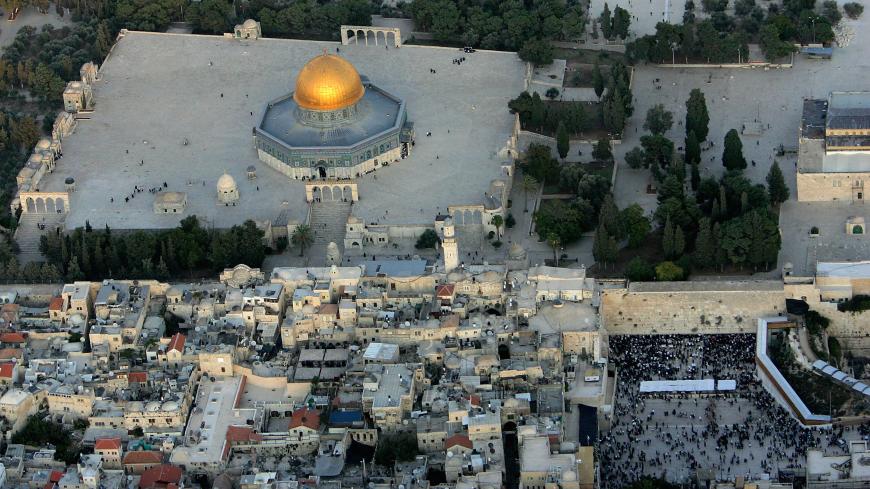 JERUSALEM, ISRAEL - OCTOBER 20: The golden Dome of the Rock Islamic shrine dominates the Temple Mount on which it stands, and at right, the Western Wall, Judaism's holiest shrine October 20, 2005 in this aerial view of Jerusalem's Old City. The picture is taken facing east. (Photo by David Silverman/Getty Images)