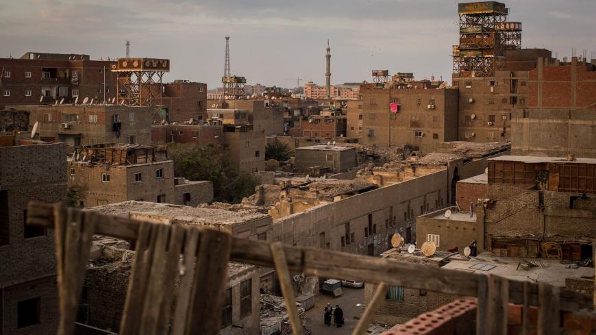 CAIRO, EGYPT - DECEMBER 15: People walk through a street in the poor neighbourhood of the "City of the Dead" on December 14, 2016 in Cairo, Egypt. The "City of the Dead" houses more than half a million people living inside the graveyard. Since the 2011 Arab Spring, Egyptians have been facing a crisis, the uprising brought numerous political changes, but also economic turmoil, increased terror attacks and the unravelling of the once strong tourism sector. In recent weeks Egypt has again been hit by multiple 