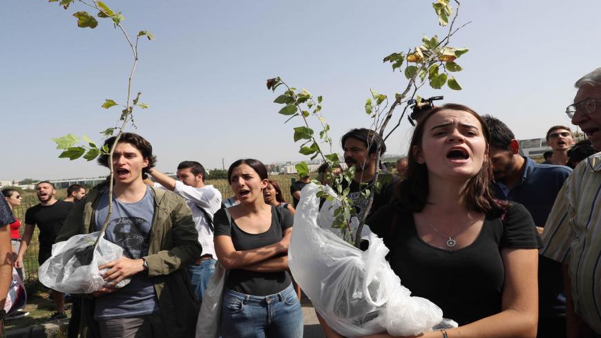 University students carrying young trees and members of the Middle East Technical Universuty (METU) graduate association protest against a road construction project to be carried out from the METU forests, on September 10, 2017 in Ankara. / AFP PHOTO / ADEM ALTAN        (Photo credit should read ADEM ALTAN/AFP via Getty Images)