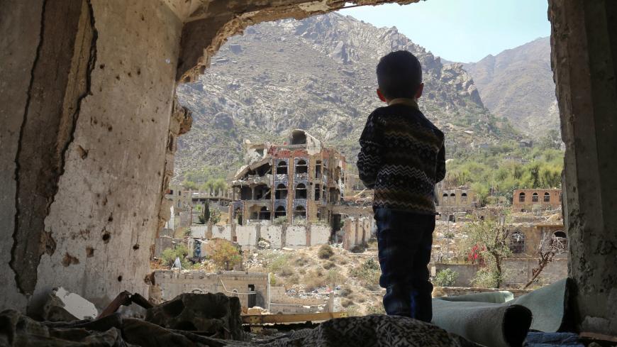 TOPSHOT - A photo taken on March 18, 2018, shows a Yemeni child looking out at buildings that were damaged in an air strike in the southern Yemeni city of Taez. / AFP PHOTO / Ahmad AL-BASHA        (Photo credit should read AHMAD AL-BASHA/AFP via Getty Images)
