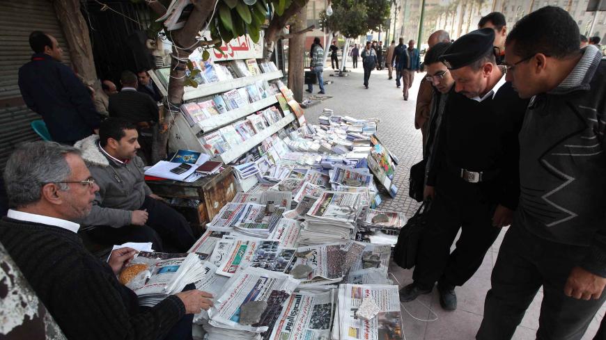 CAIRO, EGYPT - JANUARY 27:  Locals look at newspapers carrying reports and pictures of street protests on January 27, 2011 in Cairo, Egypt. Thousands of police are on the streets of the capital and hundreds of arrests have been made in an attempt to quell anti-government demonstrations.  (Photo by Peter Macdiarmid/Getty Images)