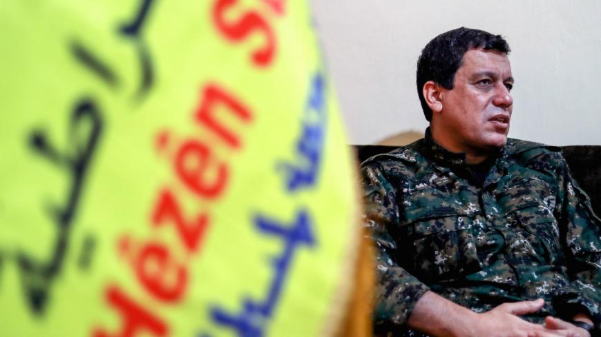 Mazloum Abdi (Kobani), commander-in-chief of the Syrian Democratic Forces (SDF), speaks with AFP during an interview in the countryside outside the northwestern Syrian city of Hasakah, in the province of the same name, on January 24, 2019. - Any deal between Syria's Kurds and the Damascus regime should respect the "special status" of Kurdish-led forces who fought the Islamic State (IS) group, Kobani said. The SDF control around a third of Syria after expelling jihadists from a large northeastern swathe of t