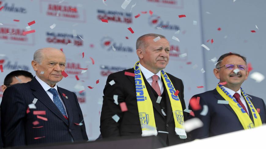 Turkish President and the leader of Turkey's ruling Justice and Development (AK) Party Recep Tayyip Erdogan (C) and leader of the Nationalist Movement Party (MHP) Devlet Bahceli stand on stage during a joint election rally of People's Alliance for the upcoming local elections in Ankara, Turkey, on March 23, 2019. - Turkish will cast their ballots for local elections on March 31, 2019. (Photo by Adem ALTAN / AFP)        (Photo credit should read ADEM ALTAN/AFP via Getty Images)