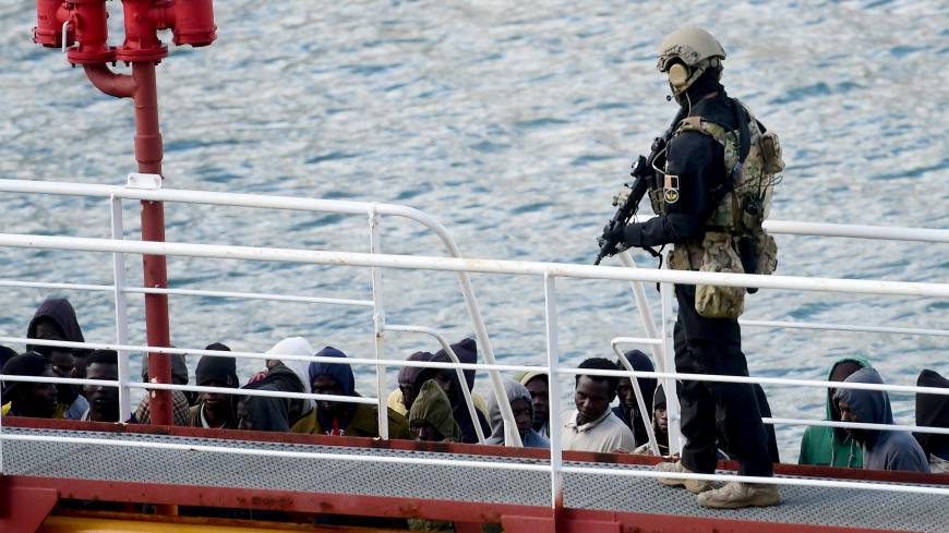 TOPSHOT - An armed policeman standds guard after migrants disembarked from the Motor Tanker El Hiblu 1 that was hijacked by migrants in Valletta's Grand Harbour on March 28, 2019, after Maltese armed forces took control of the vessel. - The intervention came after migrants hijacked a merchant ship that rescued them off the coast of Libya and ordered it to head towards Italy, the Italian government said on March 27, 2019. (Photo by JONATHAN BORG / AFP) (Photo by JONATHAN BORG/AFP via Getty Images)