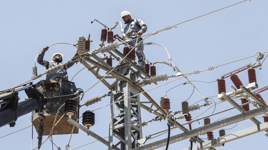 Palestinian electricity company workers inspect power installations in the town of Rafah, in the southern Gaza Strip on June 25, 2019. - Israel blocked fuel deliveries to the Gaza Strip today, citing new incendiary balloons from the Palestinian enclave.
Lacking natural resources, the Gaza Strip suffers from a chronic shortage of water, electricity and petrol. More than two-thirds of the population depends on humanitarian aid. (Photo by SAID KHATIB / AFP)        (Photo credit should read SAID KHATIB/AFP via 
