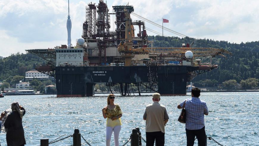 People watch as Scarabeo 9, a 115-meter-long and 78-meter-high Frigstad D90-type semi-submersible drilling rig, passes on the Bosphorus Strait en route to the Black Sea in Istanbul on August 29, 2019. - The semi-submersible drilling rig is owned and operated by Italian oil and gas industry contractor Saipem and registered in Nassau, Bahamas. (Photo by Ozan KOSE / AFP)        (Photo credit should read OZAN KOSE/AFP via Getty Images)