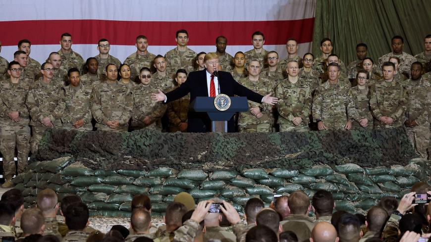 (FILES) In this file photo taken on November 28, 2019, US President Donald Trump speaks to the troops during a surprise Thanksgiving day visit at Bagram Air Field in Afghanistan. - President Donald Trump has shattered through norms and niceties on the world stage in his nearly three years in office. Entering an election year, Trump is unlikely to slow down as he seeks what has largely eluded him -- a headline-grabbing victory. The tycoon turned president closes 2019 with a new stride after what was perhaps 
