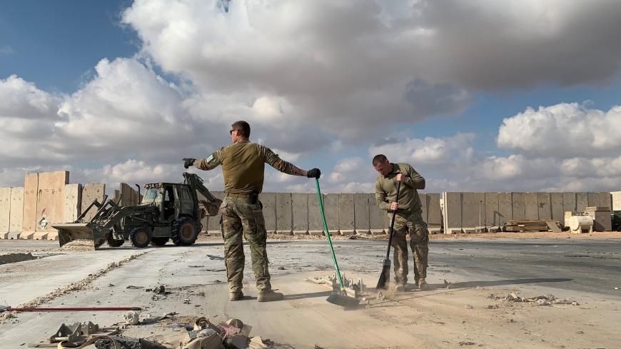 A picture taken on January 13, 2020 during a press tour organised by the US-led coalition fighting the remnants of the Islamic State group, shows US soldiers clearing rubble at Ain al-Asad military airbase in the western Iraqi province of Anbar. - Iran last week launched a wave of missiles at the sprawling Ain al-Asad airbase in western Iraq and a base in Arbil, capital of Iraq's autonomous Kurdish region, both hosting US and other foreign troops, in retaliation for the US killing top Iranian general Qasem 