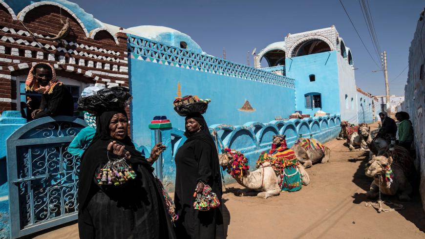 Nubian Egyptian women sell souvenirs in the village of Gharb Suhail near Aswan in Upper Egypt, some 920 kilometres south of the capital Cairo, on February 5, 2020. - The Nubian language, according to locals, is unpractised by many in the generation born decades after their mass eviction from their ancestral lands to make way for the construction of the Aswan High Dam on the Nile in the 1960s. Built under Egypt's late president Gamal Abdel Nasser, the colossal project aimed to harness the Nile's annual flood